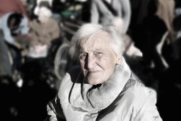 Old lady with alzheimer's in a crowd looking lost