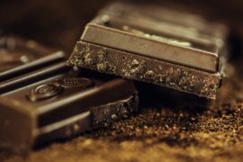 Close up of 2 squares of very dark chocolate containing flavanols