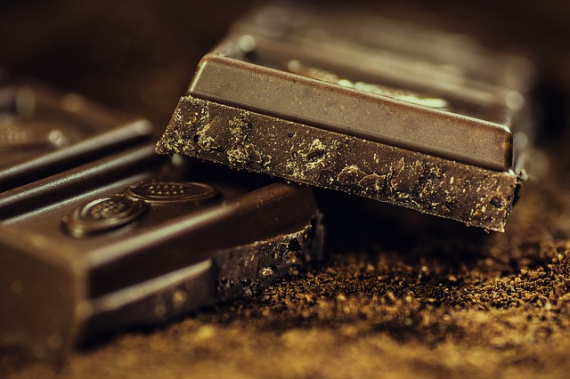 Close up of 2 squares of very dark chocolate containing flavanols