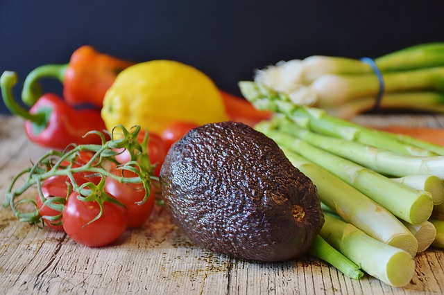 Selection of vegetables on a wooden chopping board demonstrating a vegan diet