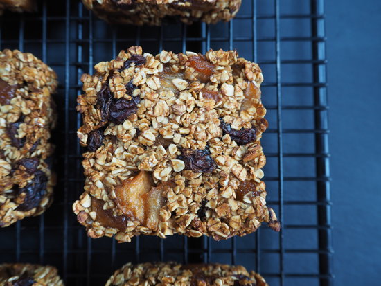 Close up of a square apple cinnamon and raisin flapjack on a wire cooling rack