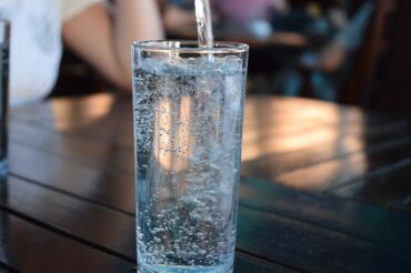 Tall glass filled with water sat on a table