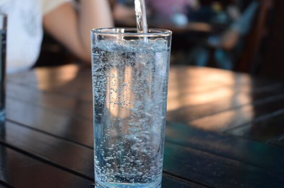 Tall glass filled with water sat on a table