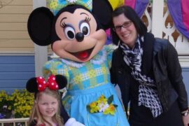 Mother and Daughter stood either side of Minnie Mouse character at Disneyland Paris