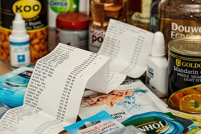 Close up of grocery food shopping with a receipt in front of it, signifying healthy food on a budget
