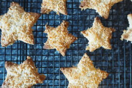 Cardamom coconut star biscuits on a wire baking rack