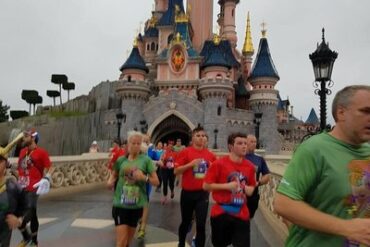Runners running through Sleeping Beauty's castle at Disneyland Paris
