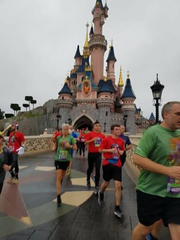 Runners running through Sleeping Beauty's castle at Disneyland Paris