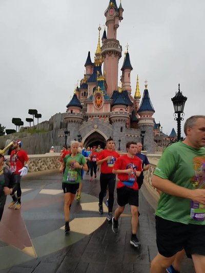 Runners running through Sleeping Beauty's castle at Disneyland Paris