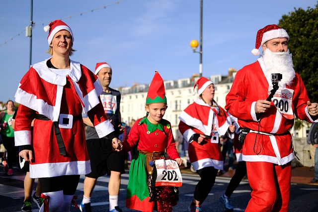 Family dressed as santas and elves running in a charity race