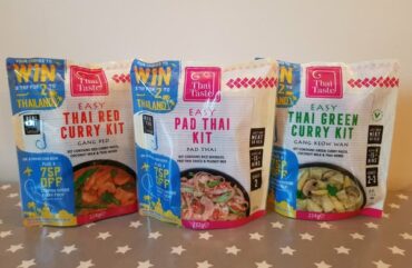 Three packets of Thai Taste mEAL kit pouches lined up on a table.