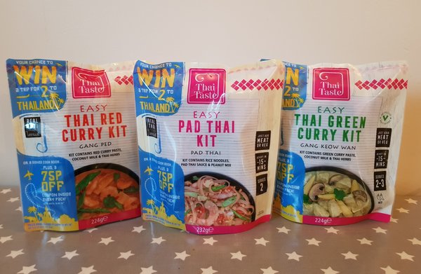 Three packets of Thai Taste mEAL kit pouches lined up on a table.