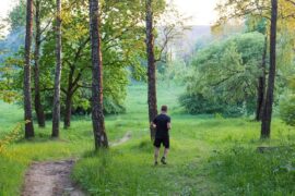 Man running through a grassy forest