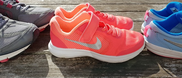 thee pairs of running trainers lined up in a row on some decking signifying how running may be one of the answers to the childhood obseoty problem in the uk