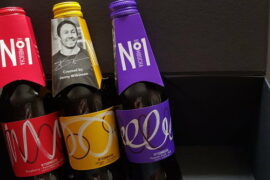 Three bottle of No1 Kombucha propped up against a black box