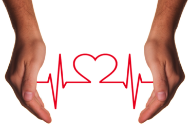 Two hands reaching down from the top of the picture. the background ios white and there is a red jagged heart beat line going between the two hands with the shape of a heart ion the centre of the image.