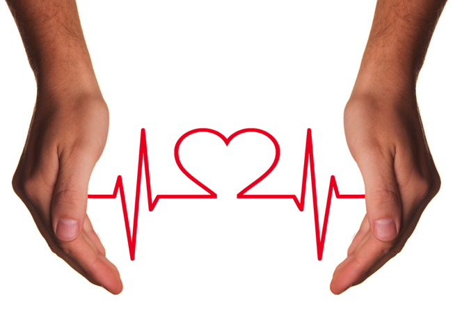Two hands reaching down from the top of the picture. the background ios white and there is a red jagged heart beat line going between the two hands with the shape of a heart ion the centre of the image.