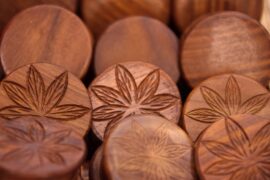 wooden discs with imprint of cannabis leaves on them to indictae the benefits of cbd for health and wellness