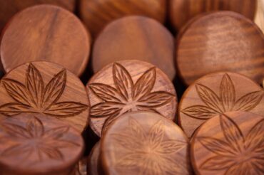wooden discs with imprint of cannabis leaves on them to indictae the benefits of cbd for health and wellness