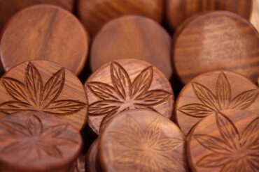 wooden discs with imprint of cannabis leaves on them to indictae the benefits of cbd for health and wellness