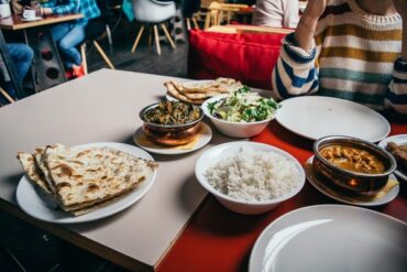 Table of bowls filled with healtbhier takeout food options