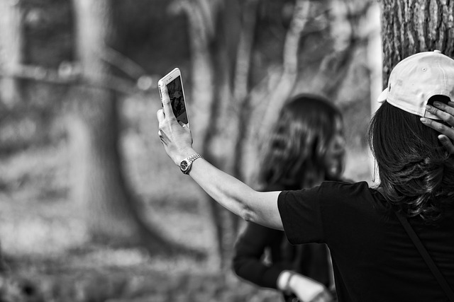 black and white photo of a long haired brunette lady taking a selfie