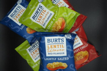 A pile of 6 packets of Burts Lentil Waves