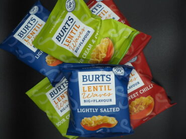 A pile of 6 packets of Burts Lentil Waves