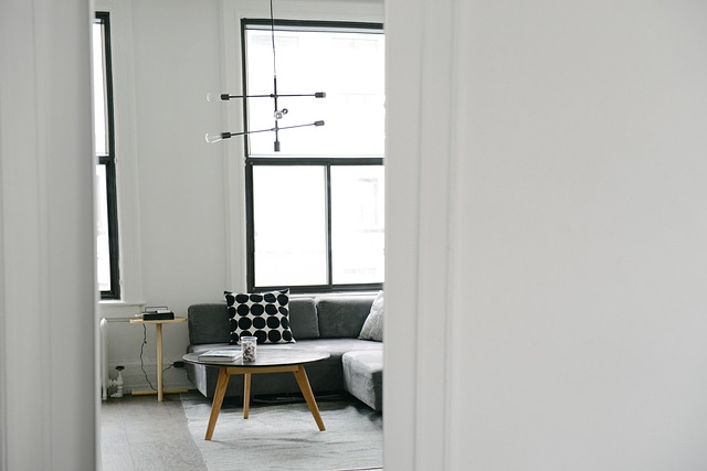 looking through a white doorway into a very modern wiary white living room that looks clean and fresh
