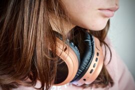 Close up of a woman wiith headphone round her neck