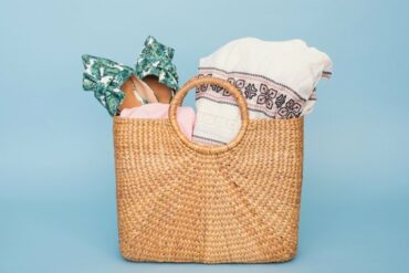 Basket style handbag filled with things you would need to take with you on a wellness retreat