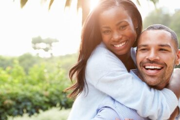 Young black couple smiling at the camera
