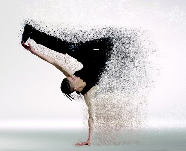 male dancer supporting himself on oone hand with the other one stretched out holding onto one of his legs. Half his body has faded away into little dts, making the image lok futuristic. Representing the future of fitness in the year 2020