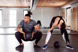 man and woman in a gym dong a HIIT workout together