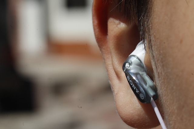 close up of a human ear with in ear headphones in