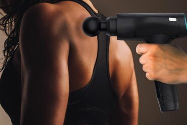 massage guin being used on a female's back