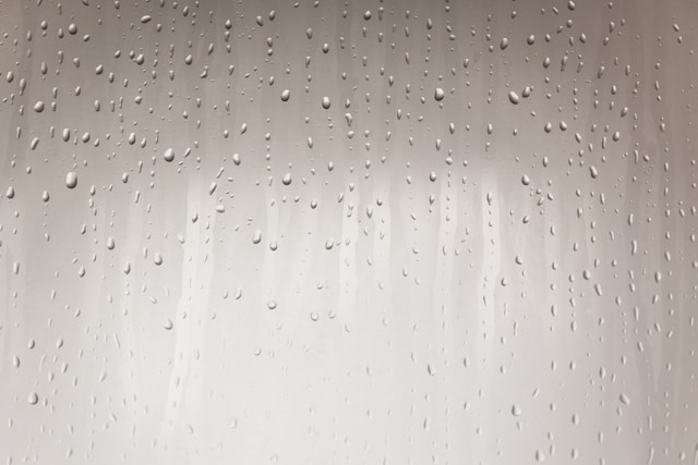 Condensation forming on the glass front of a refrigerated drinks cabinet